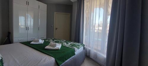 a bedroom with a bed with two pillows on it at Ela, Kedar 5 in Sveti Vlas
