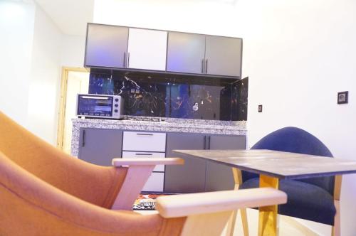 a table and chairs in a room with a table and a microwave at 2 Voies Résidence in Dakhla