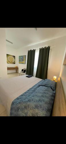 a bedroom with a large bed and a window at San Pantaleone Appartamento Salento in Martignano