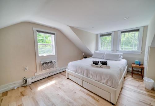 a bedroom with a bed with two shoes on it at 3 Bedroom Cape House by Leavetown Vacations in Sandwich