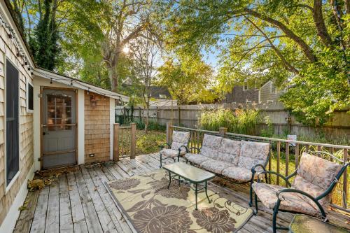 a patio with two chairs and a table on a deck at Babes Bungalow by Leavetown Vacations in Orleans