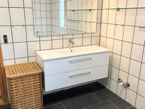 a bathroom with a white sink and a mirror at 8 person holiday home in Hadsund-By Traum in Odde