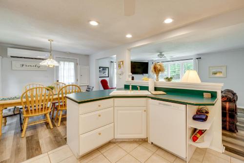 a kitchen and dining room with a table and chairs at Outdoor Exploration Quaint North Conway Cottage! in North Conway