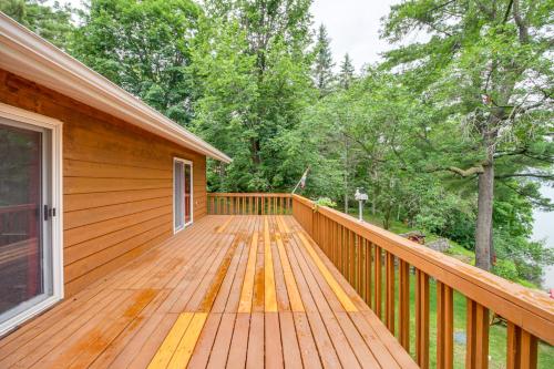 a wooden deck on a house with trees at Dock, Deck and Fire Pit Lakefront Home in Walker! in Walker