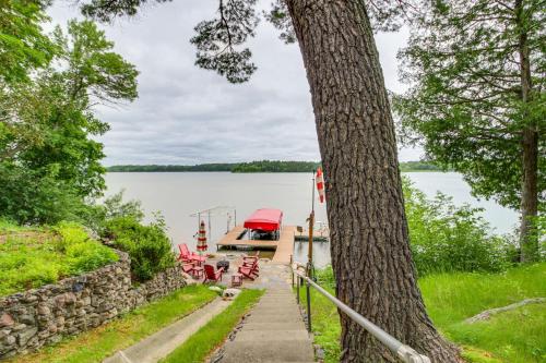 a boat is docked at a dock on a lake at Dock, Deck and Fire Pit Lakefront Home in Walker! in Walker