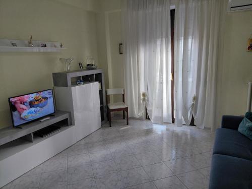 a living room with a tv and a couch at CROTONE Mare&Confort in Crotone