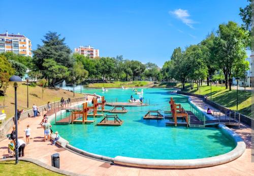 a park with people playing in the water at Peaceful Stay - Lisbon in Amadora