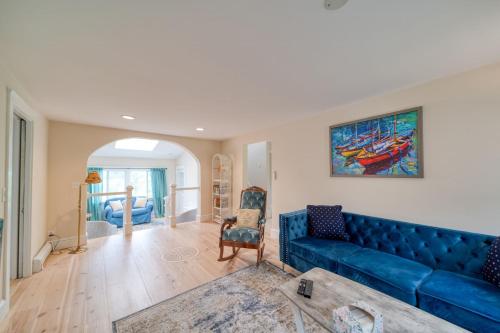 a living room with a blue couch and a painting at 3 Bedroom Cape House by Leavetown Vacations in Sandwich