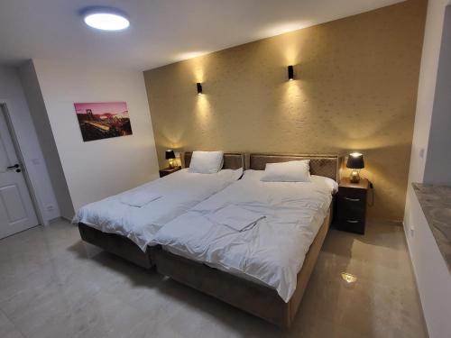 a bedroom with a large bed with white sheets at InterPension in Garbsen