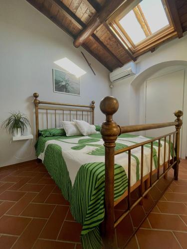 a bedroom with a bed with a green and white comforter at Casa Pierina in Vicchio