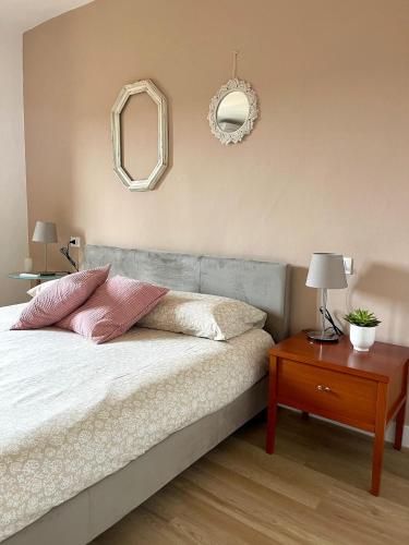 a bedroom with a bed with two pillows and a table at Casa Pierina in Vicchio