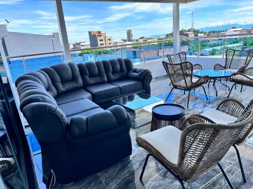 a living room with a couch and tables and chairs at Hotel Costa Norte in Necoclí