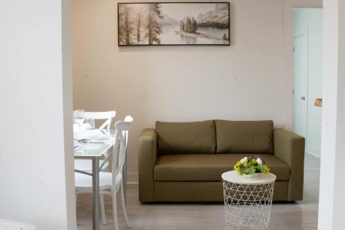 a living room with a couch and a table at Douce Evasion in Rouyn