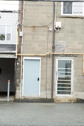 a white door on the side of a brick building at Douce Evasion in Rouyn