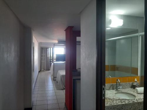 a bathroom with a sink and a mirror at Imo Apart Pipa's Ocean in Pipa