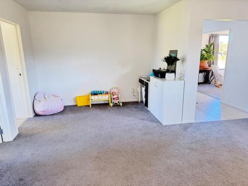 an empty room with a white wall and a desk at Private oasis and kid friendly space in Methven