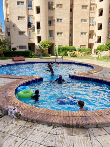 a group of people playing in a swimming pool at Chalet with garden Compound group 02 in Alexandria
