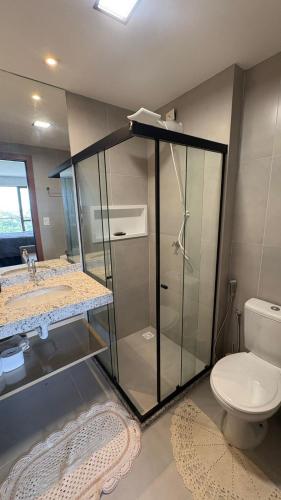 a bathroom with a glass shower and a toilet at Studio em Salvador- Vista Mar in Salvador