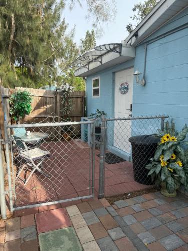 a fence in front of a house with a patio at Studio Yunet in Bradenton