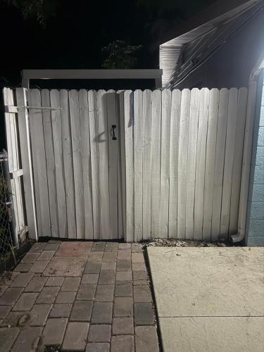a white fence in front of a house at Studio Yunet in Bradenton