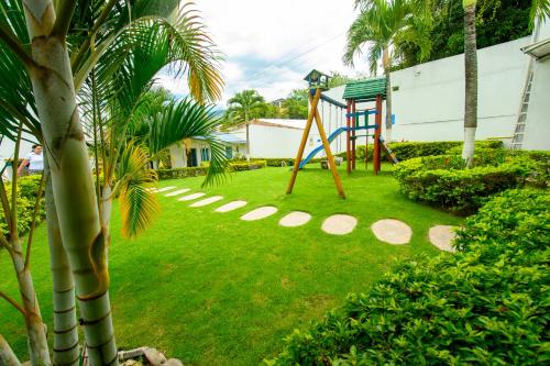 a playground in the yard of a house at Hotel Villeta Suite in Villeta