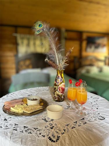 a table with a plate of food and two glasses of orange juice at Ana Cereza Chalet in Nuevo Colón