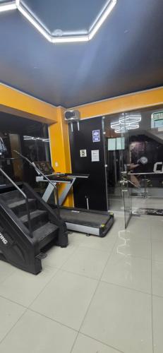 a room with two beds and a table in a building at CLUB 33 FIT Hotel Gym in Huancayo