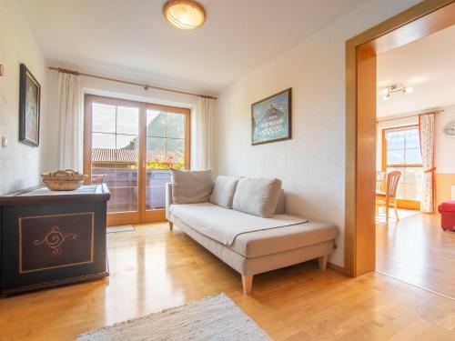 a living room with a couch and a window at Schleicherhof I in Strass im Zillertal