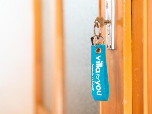 a blue tag on a door with a key at Schleicherhof I in Strass im Zillertal