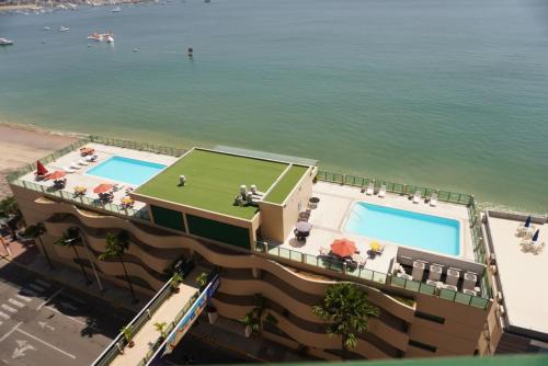 an aerial view of a resort with a tennis court and the water at Hotel Colon Salinas 2 bedroom Oceanview apartment in Salinas