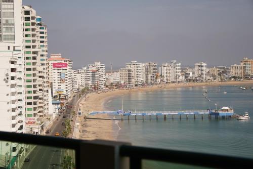 a view of a beach and the ocean with buildings at Hotel Colon Salinas 2 bedroom Oceanview apartment in Salinas