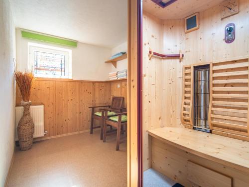 a room with a table and a wooden wall at Schleicherhof I in Strass im Zillertal