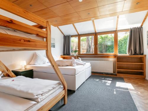 two bunk beds in a room with wooden ceilings at Gaisberg Alpin in Kirchberg in Tirol