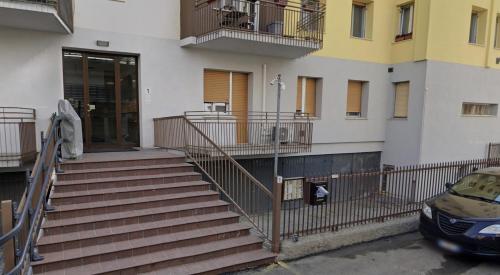 a building with stairs and a car parked in front at Casa Amelia Elegant Suite parcheggio gratuito in Parma