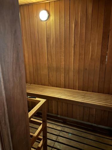 a wooden sauna with a light on top of it at Duplex com garagem em Itaipava in Itaipava