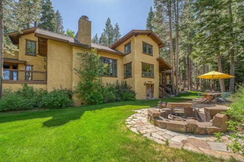 a house with a fire pit in the yard at Star Haven Game Room & Forest Views in Truckee