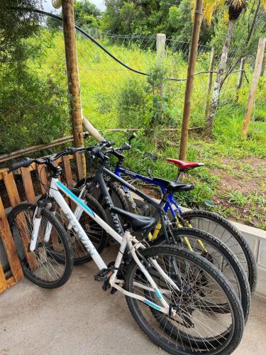 two bikes are parked next to a bench at Docas da Lapa in Santana do Riacho