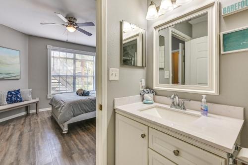 a bathroom with a sink and a bedroom with a bed at Saltwater Pool and 4 Mi to Beach Clearwater Condo! in Clearwater