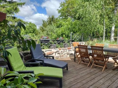 a deck with chairs and a table and a table and chairs at Grande maison au cœur d'un village historique avec terrasse et WIFI inclus - FR-1-582-308 in Saint-Vidal
