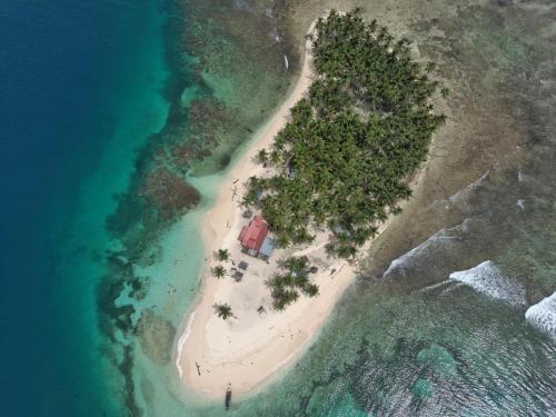 an island with a house on an island in the ocean at Camping Tent on Guna Yala Island in Panama City