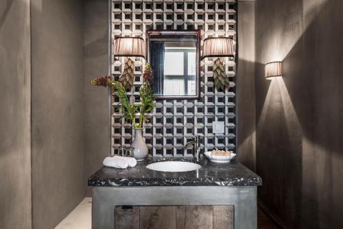 a bathroom with a sink and a mirror at Odevaere - Charming & luxurious apartment with terrace in Bruges