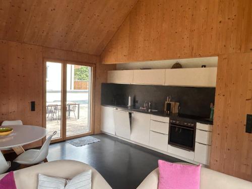 a living room with a kitchen and a table with a dining room at Dorfschmiede in Hüttlingen