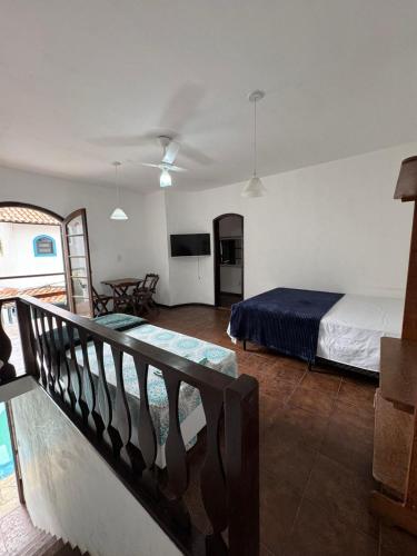 una habitación de hotel con una cama y un balcón en Suites dos Anjos, en Arraial do Cabo