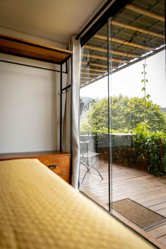a bedroom with a bed and a sliding glass door at Docas da Lapa in Santana do Riacho