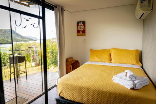 a bedroom with a bed with a towel on it at Docas da Lapa in Santana do Riacho