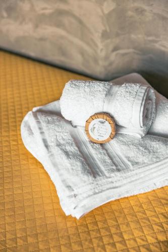 a white towel with a watch on a bed at Docas da Lapa in Santana do Riacho