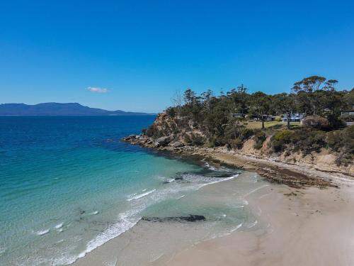 a view of a beach with the ocean at Cliff-Top Retreat Ocean Views in Spring Beach