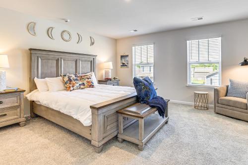 um quarto com uma cama grande e uma cadeira em Pool Access, 2 Mi to Main St Fountain Inn Home! em Simpsonville