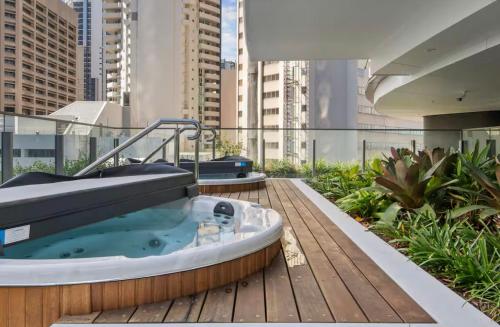 a hot tub on the roof of a building at Luxury apartment at Queens Wharf Tower in Brisbane