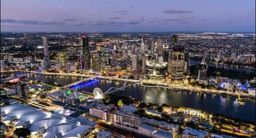 a view of a city at night at Luxury apartment at Queens Wharf Tower in Brisbane